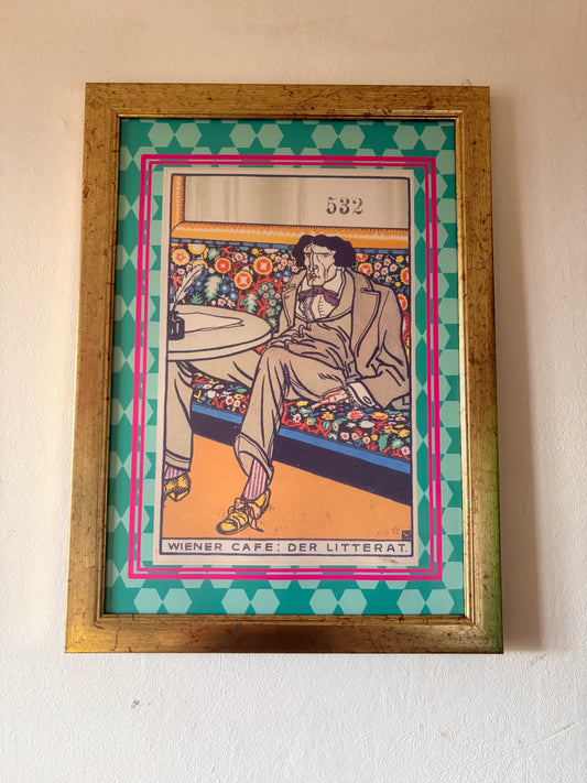 Framed artwork of a person sitting on a bench with colorful design elements.