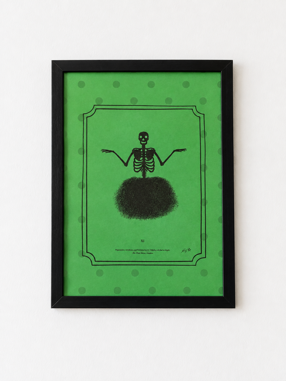 A framed art print featuring a black skeleton figure with outstretched arms on a bright green background with subtle green polka dots, enclosed in a black frame against a white wall.