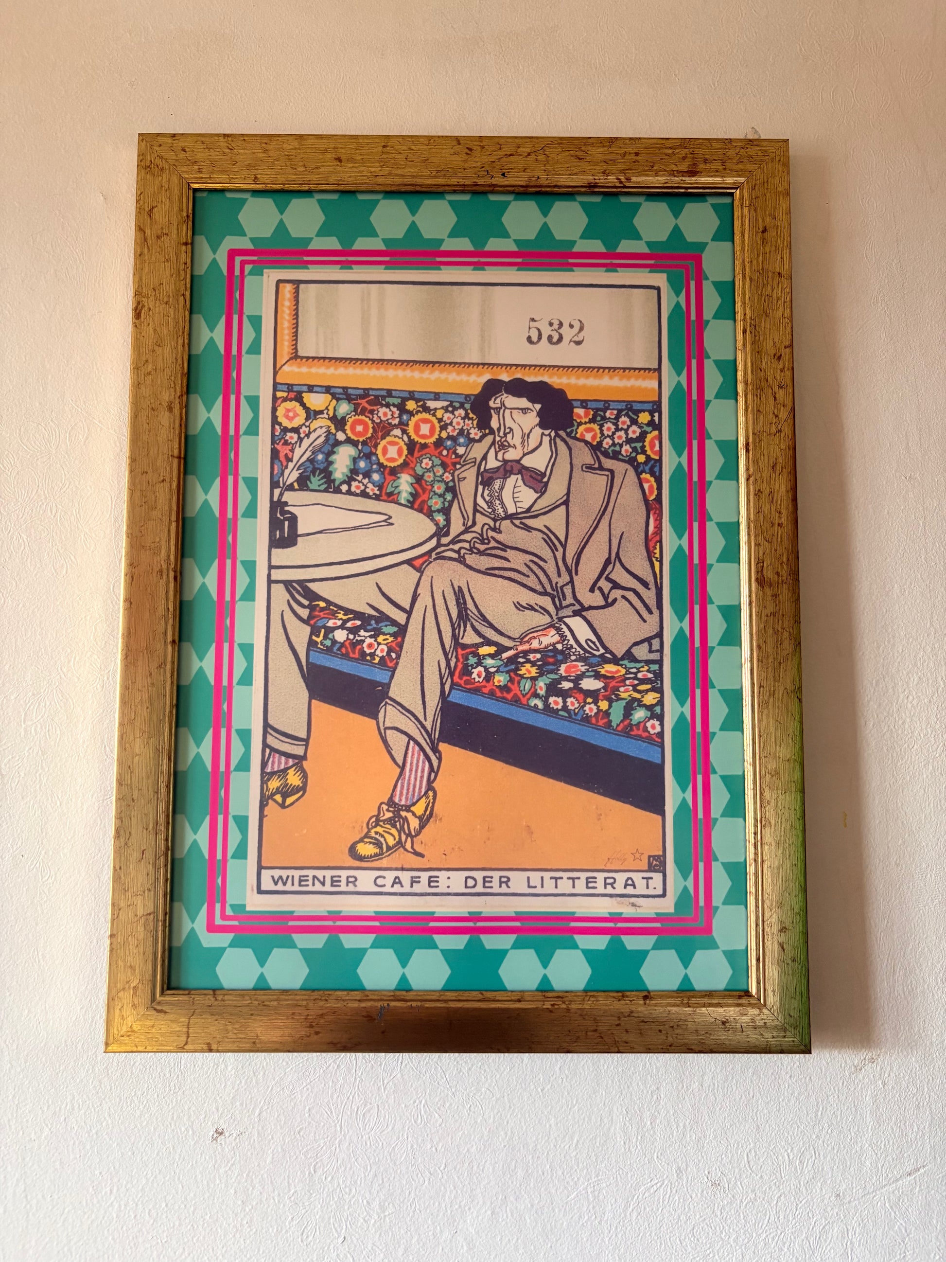 Framed artwork of a person sitting on a bench with colorful design elements.